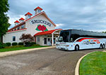A Christian Tour bus stops at the J.M. Smuckers Store & Cafe in Ohio. thumbnail